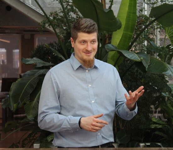 Therapist standing up, explaining and gesturing to people